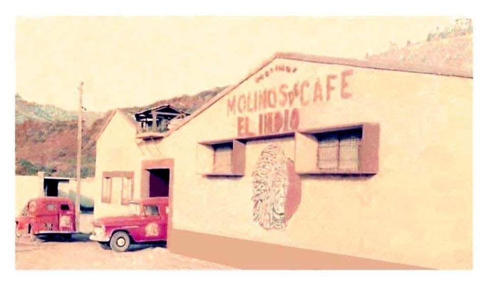 The Molinos de Café El Indio mill in Honduras with the company's red delivery trucks parked outside